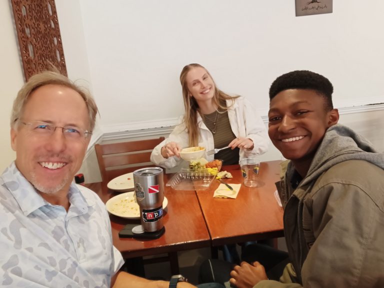 Providence Christian Montessori students and a mentor sharing a meal during a student internship experience, building professional relationships and real-world career skills.